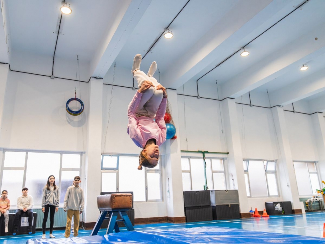 a teenager doing flips on a trampoline.jpg