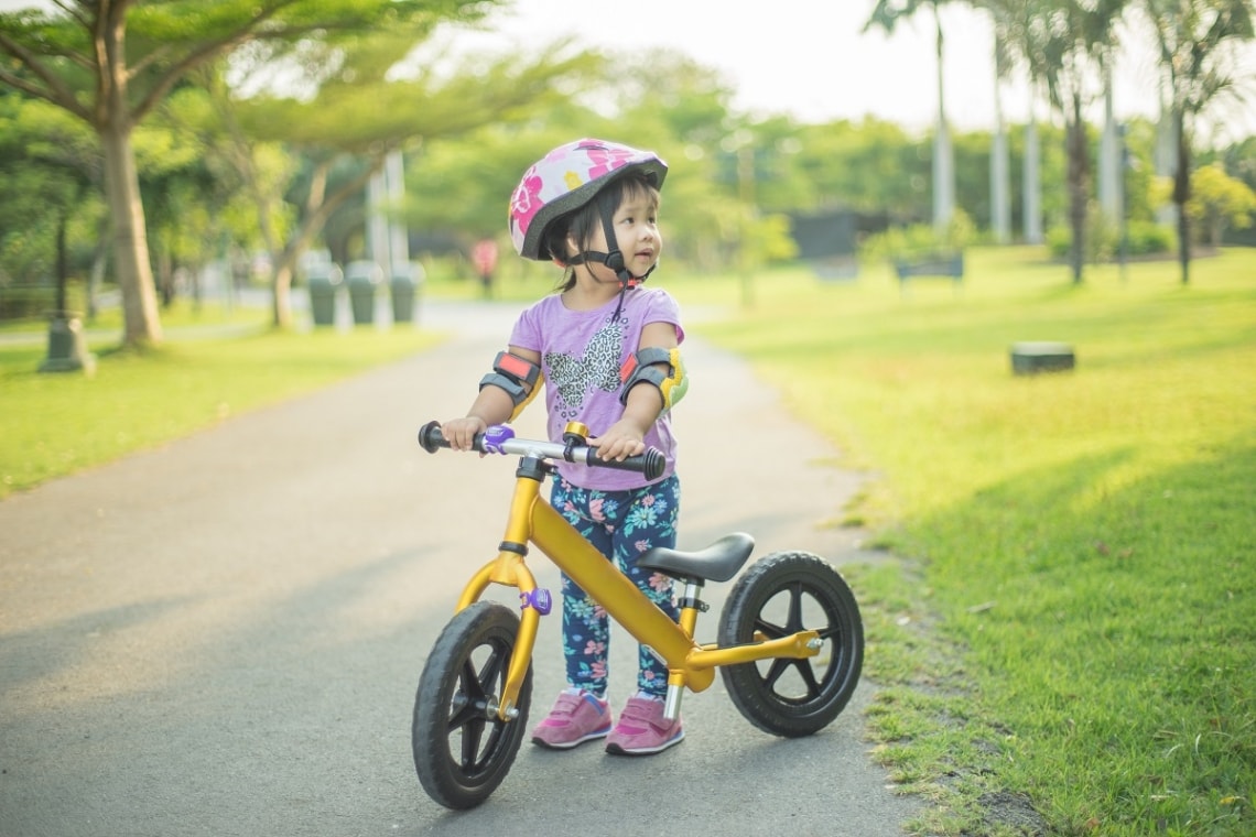 Young child on her balance bike