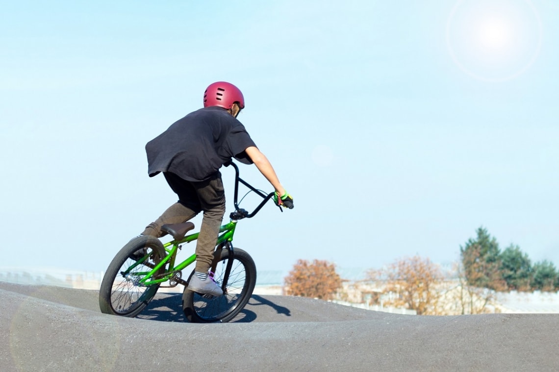 Kid on his BMX bike at a skate park