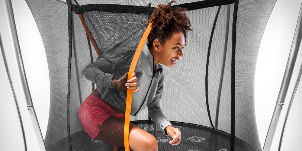 Young girl exiting the safety net of a Vuly Thunder trampoline