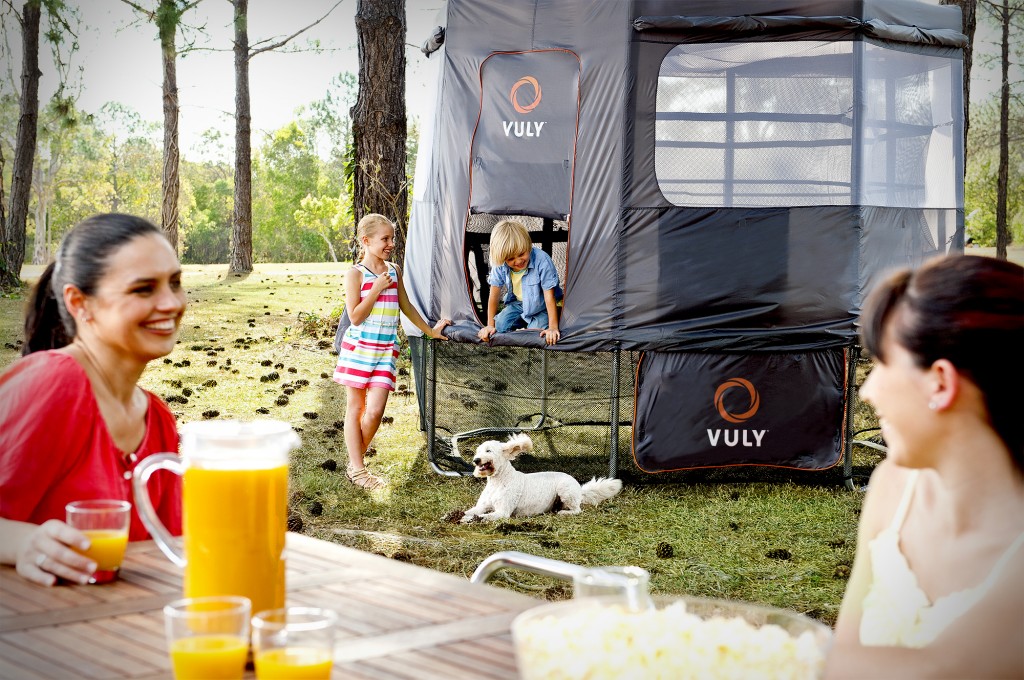 Parents watching their kids play on a Vuly trampoline