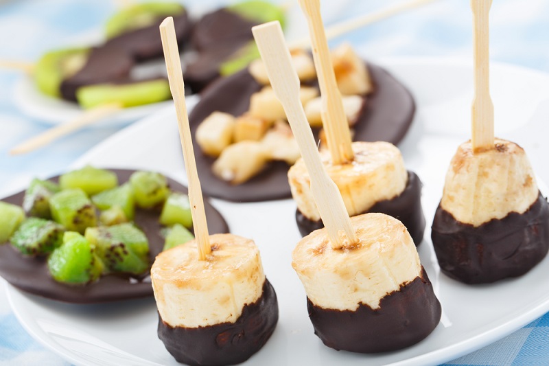 Choc dipped banana pieces served on a plate