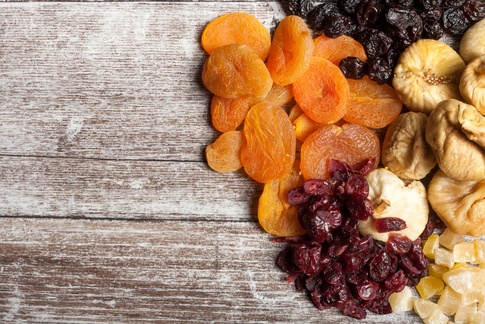 Various dried fruits placed on a wooden table