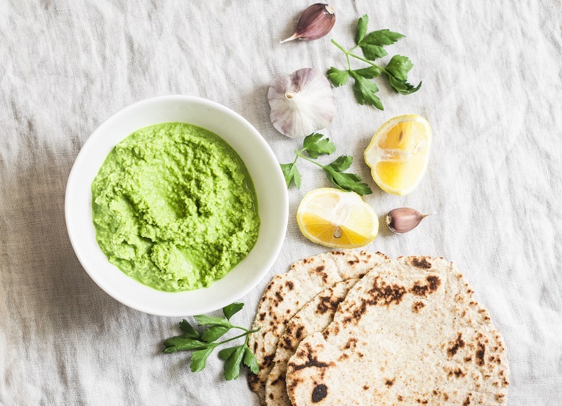 Flatbread and guacamole sitting on a table