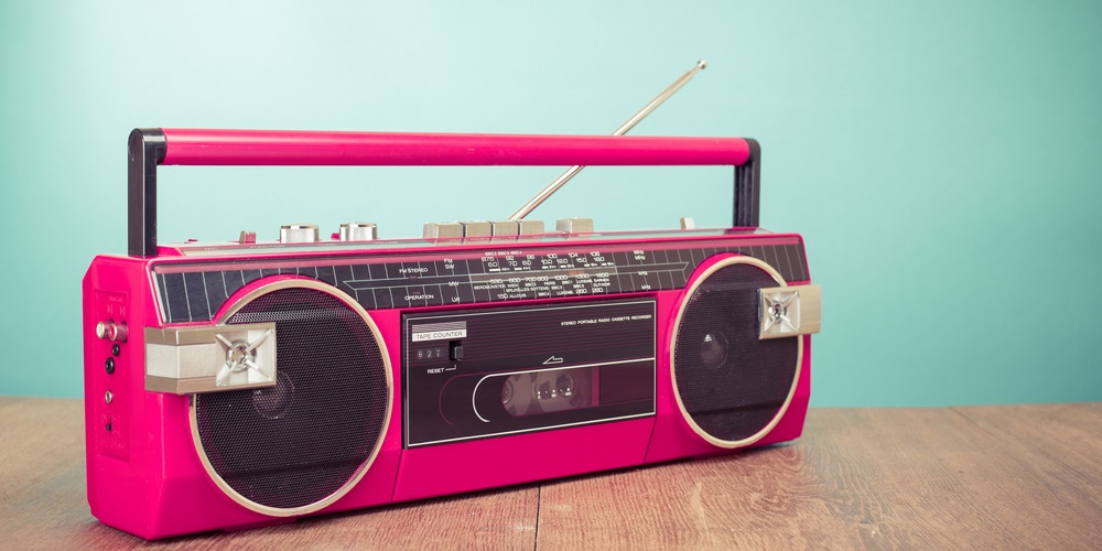 Pink radio player sitting on wooden bench