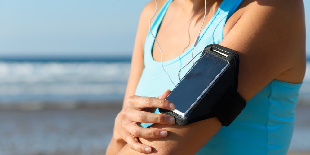 Woman jogging with a smartphone armband