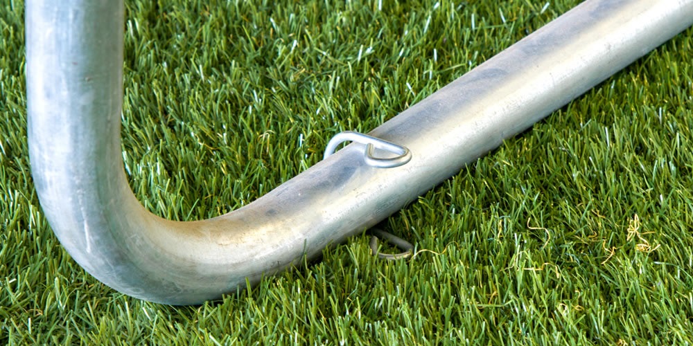 Close up of trampoline leg with grass under