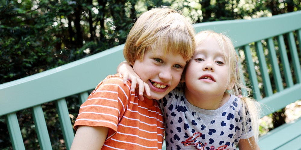 young boy and girl hugging