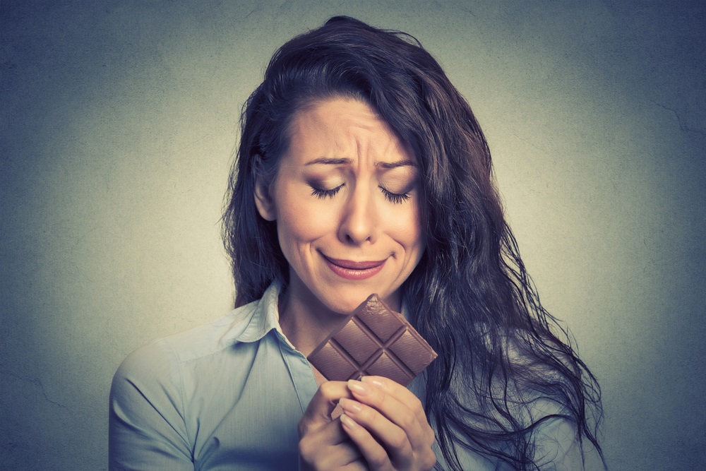 Woman holding and craving chocolate