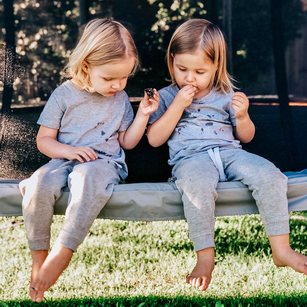 Twins playing on trampoline 