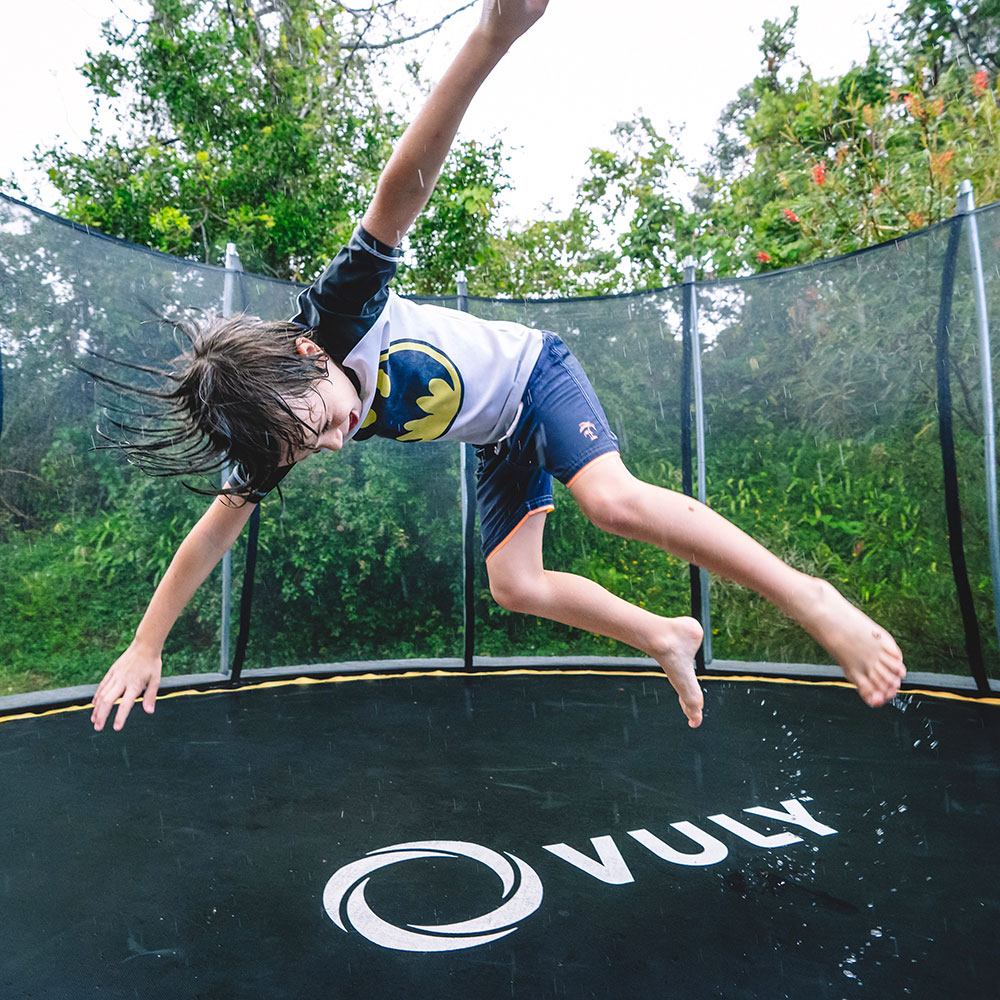 Jumping on a trampoline in the rain. 