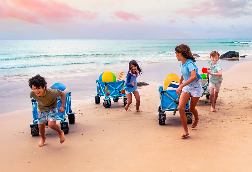 Kids playing on the beach with their wagons