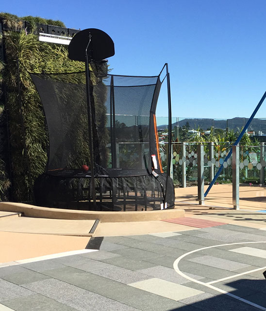 Sponsored trampoline with basketball hoop.